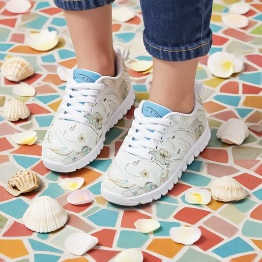 Girls’ Santorini Travel Sneakers on colorful tiles with seashells and flower petals.