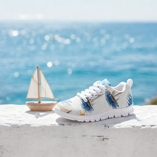 Boys’ Santorini Travel Sneakers displayed by the sea with a decorative sailboat in the background.