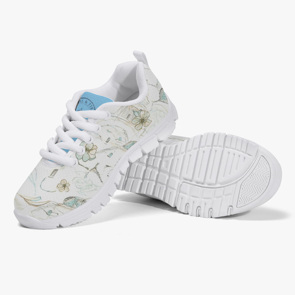 Girls’ Santorini Travel Sneakers featuring a floral design with white sole and breathable mesh upper.